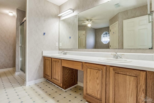 bathroom with an enclosed shower, vanity, and ceiling fan