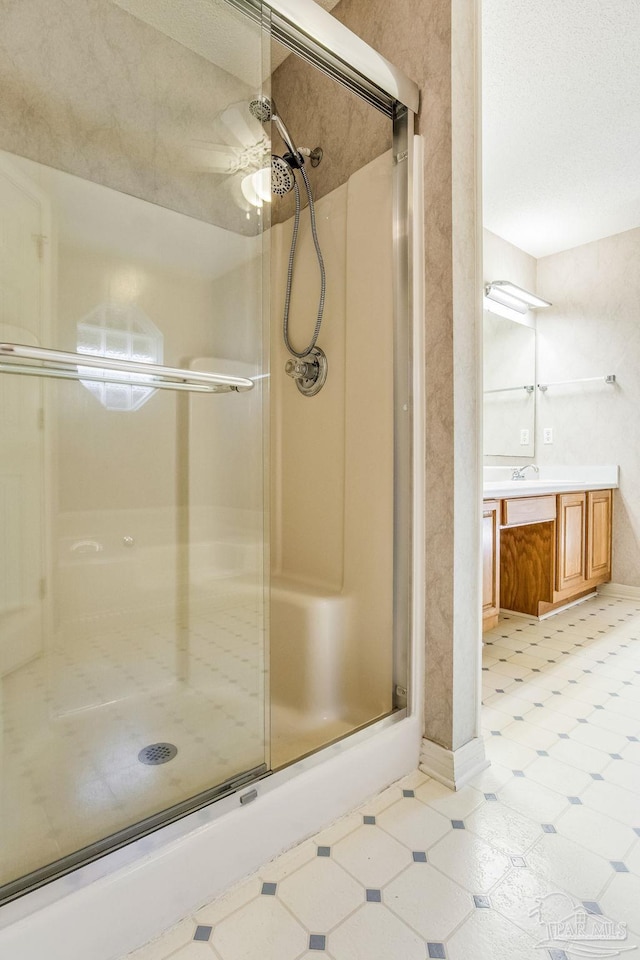 bathroom with vanity and a shower with shower door