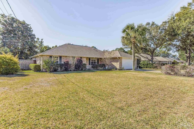 ranch-style house featuring a garage and a front yard