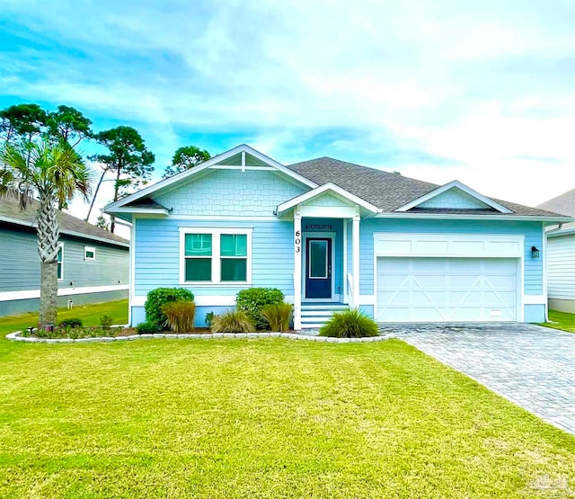 view of front of property with a front yard and a garage