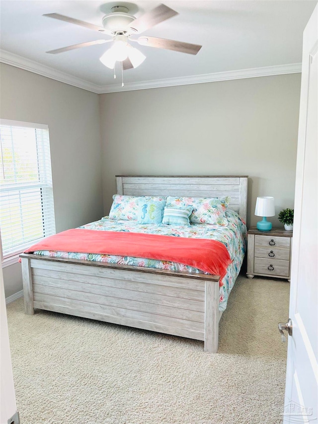 carpeted bedroom with multiple windows, ceiling fan, and crown molding