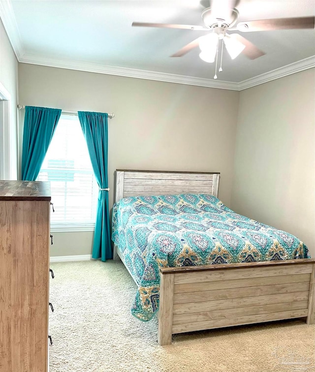 bedroom featuring ceiling fan, crown molding, and carpet