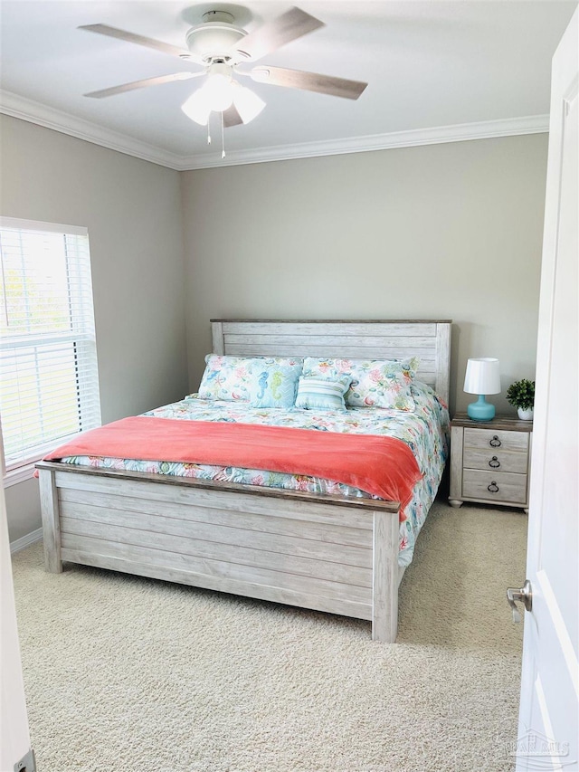 bedroom with ceiling fan, crown molding, and carpet