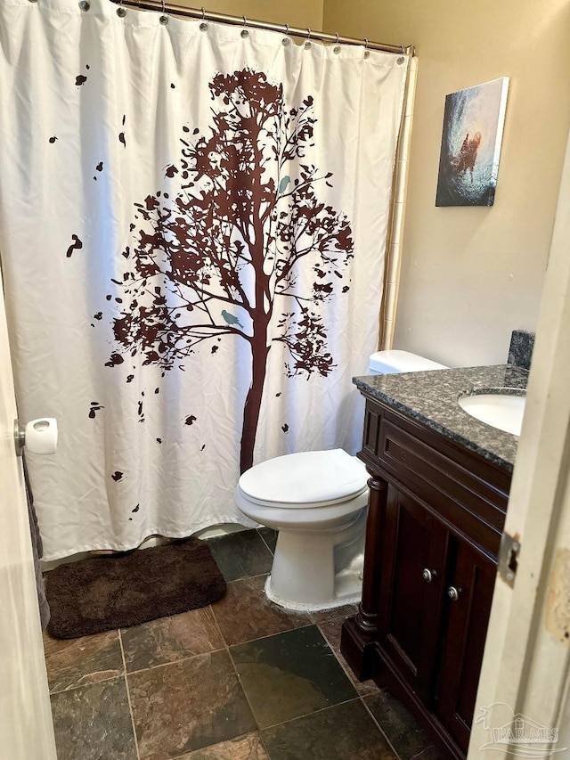 bathroom featuring vanity and toilet