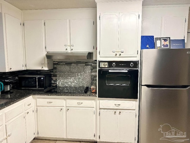 kitchen featuring tasteful backsplash, white cabinets, dark stone counters, and black appliances