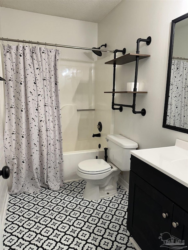 full bathroom with vanity, a textured ceiling, shower / tub combo with curtain, and toilet