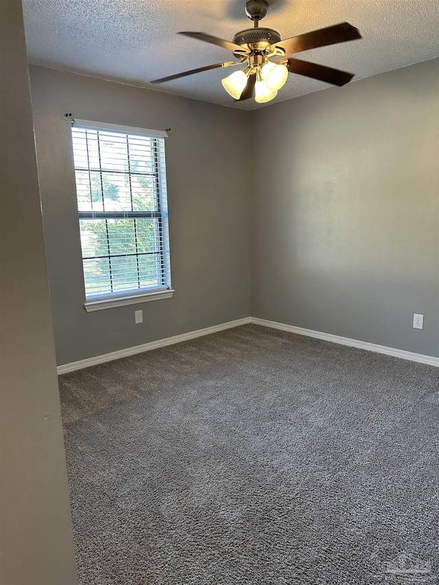 carpeted spare room featuring a textured ceiling and ceiling fan