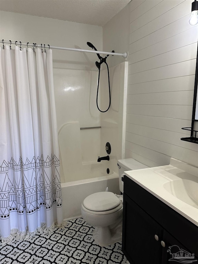 full bathroom with vanity, toilet, shower / bathtub combination with curtain, and a textured ceiling