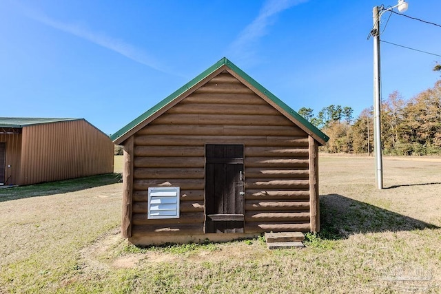 view of outbuilding featuring a lawn