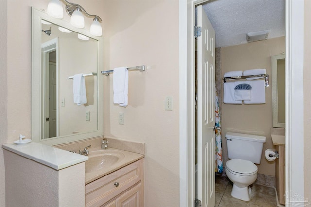 full bath with tile patterned floors, vanity, and toilet