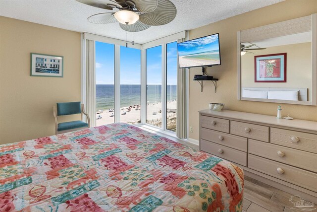 13753 Perdido Key Dr Unit 608, Pensacola, FL 32507 - bedroom featuring access to exterior, ceiling fan, a textured ceiling, and wood finished floors