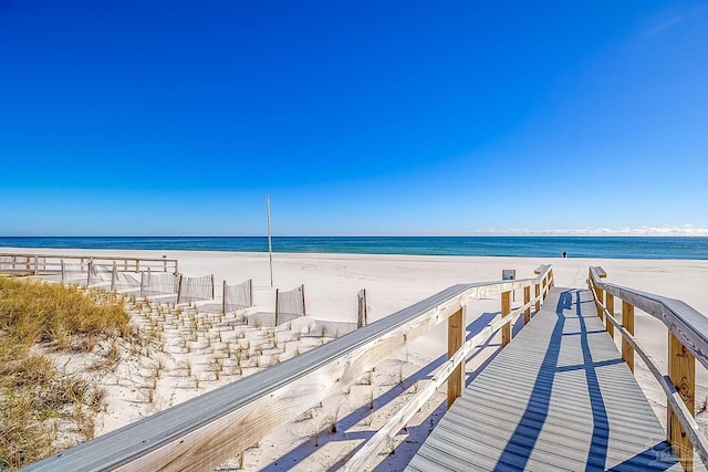 surrounding community with a beach view and a water view