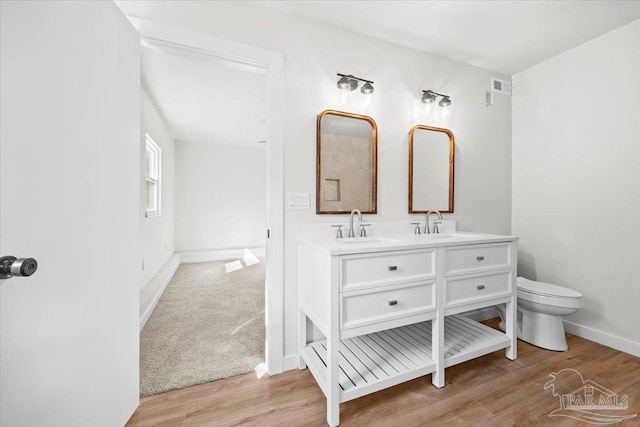 bathroom featuring vanity, toilet, and wood-type flooring