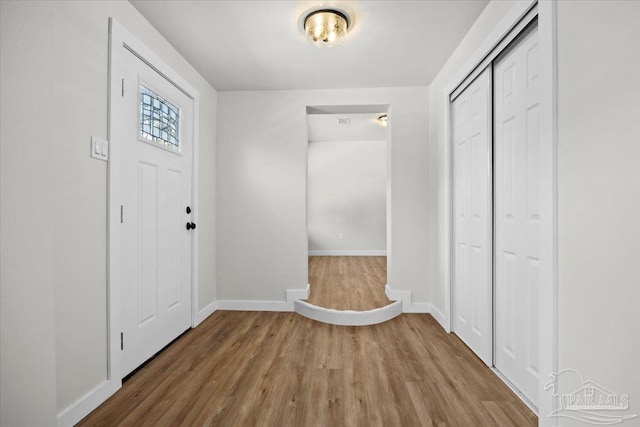 entryway with hardwood / wood-style floors