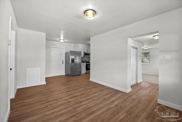 unfurnished living room featuring dark wood-type flooring