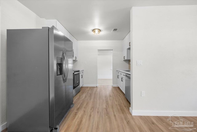 kitchen with white cabinets, stainless steel appliances, and light hardwood / wood-style flooring