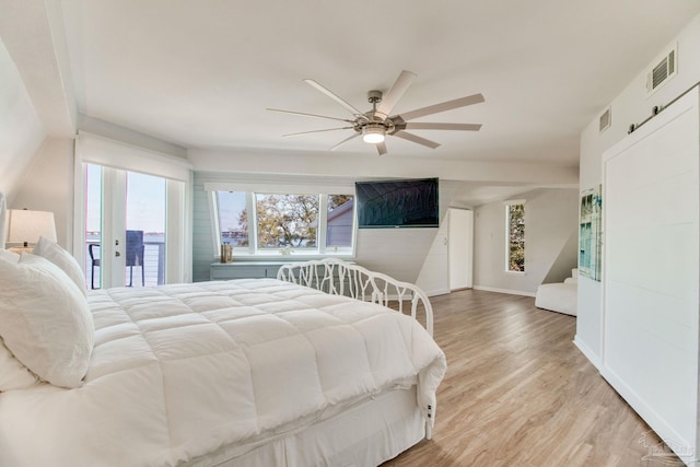 bedroom featuring access to exterior, light wood-style floors, visible vents, and ceiling fan