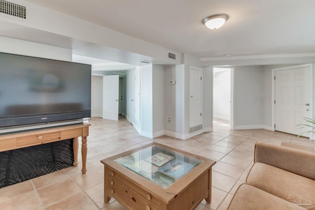 living room with visible vents, baseboards, and light tile patterned flooring