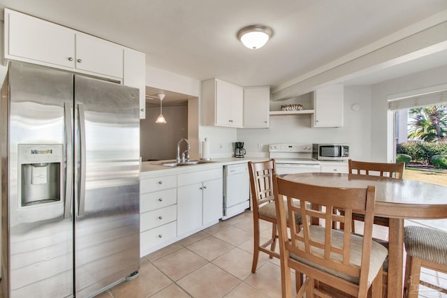 kitchen with a sink, open shelves, stainless steel appliances, light tile patterned flooring, and light countertops