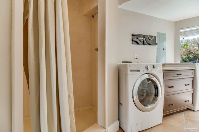 laundry room with light tile patterned floors, washer / clothes dryer, and laundry area