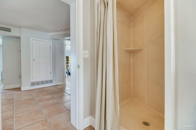 bathroom featuring tile patterned floors, baseboards, visible vents, and a stall shower