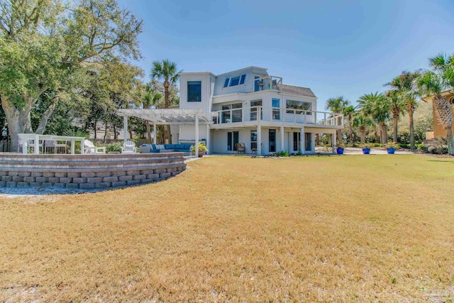 back of house featuring a lawn, a pergola, and stucco siding