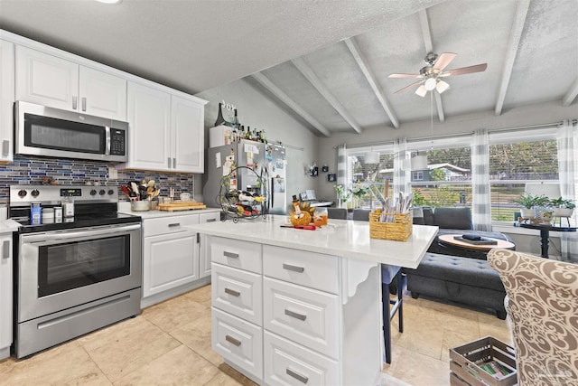 5607 Fairview Dr, Pensacola, FL 32505 - kitchen featuring appliances with stainless steel finishes, tasteful backsplash, light countertops, ceiling fan, and white cabinets