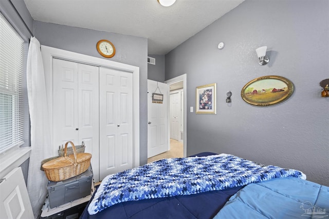 5607 Fairview Dr, Pensacola, FL 32505 - bedroom with a closet, a textured wall, and a textured ceiling