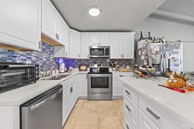 5607 Fairview Dr, Pensacola, FL 32505 - kitchen featuring stainless steel appliances, a sink, tasteful backsplash, and light countertops