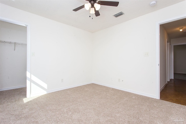 unfurnished bedroom with a closet, ceiling fan, and carpet