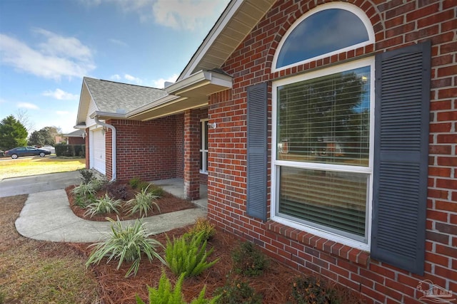 view of side of home featuring a garage