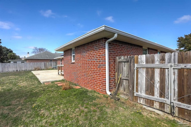 view of home's exterior featuring a patio and a lawn