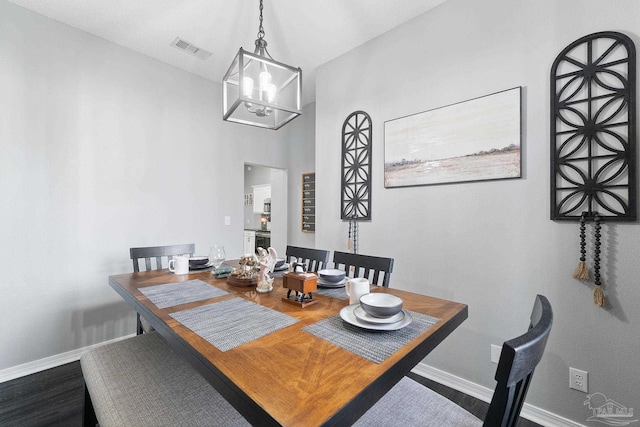 dining area featuring an inviting chandelier and hardwood / wood-style floors