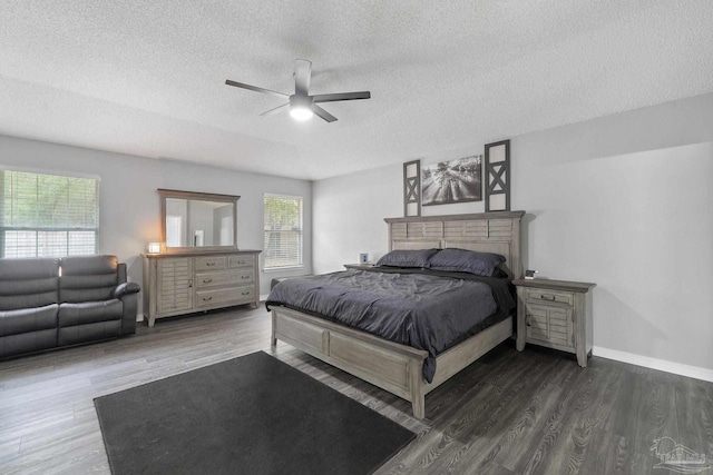 bedroom featuring ceiling fan, a textured ceiling, and dark hardwood / wood-style flooring