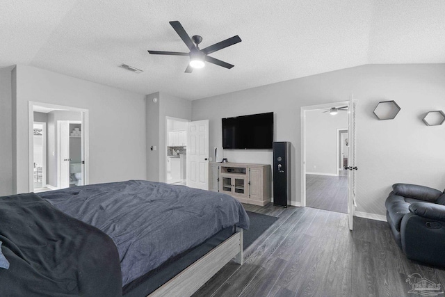 bedroom featuring ceiling fan, dark hardwood / wood-style flooring, vaulted ceiling, and a textured ceiling