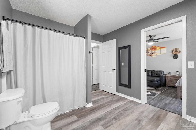 bathroom featuring hardwood / wood-style flooring, a textured ceiling, and toilet