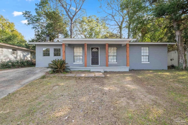 ranch-style house featuring a porch and a front lawn