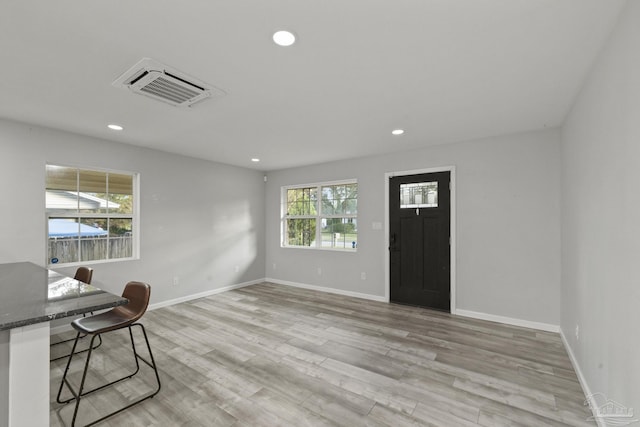 unfurnished office with light wood-type flooring