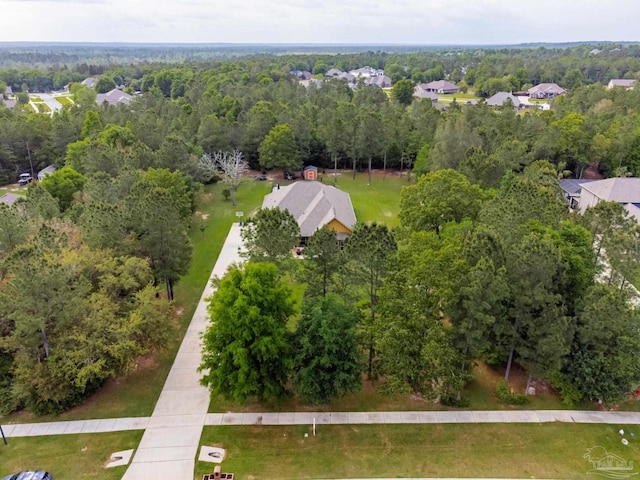 birds eye view of property with a wooded view