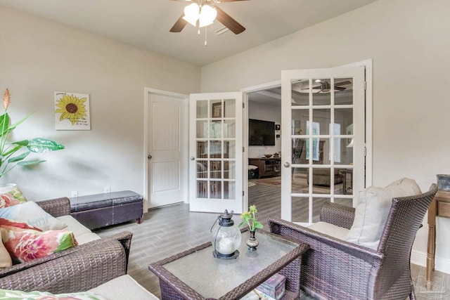 living area featuring visible vents, french doors, wood finished floors, and a ceiling fan