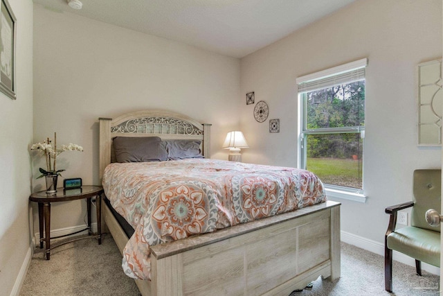 bedroom featuring carpet and baseboards
