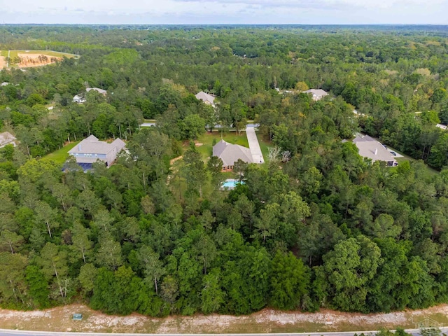 birds eye view of property with a view of trees