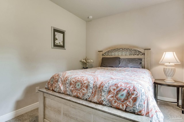 bedroom with baseboards and carpet
