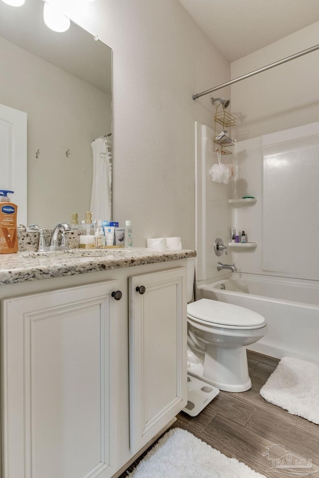 full bathroom featuring vanity, toilet, shower / tub combo with curtain, and wood finished floors