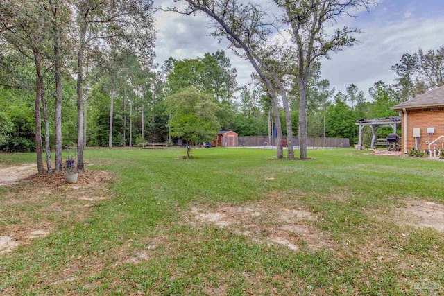 view of yard featuring a pergola and fence