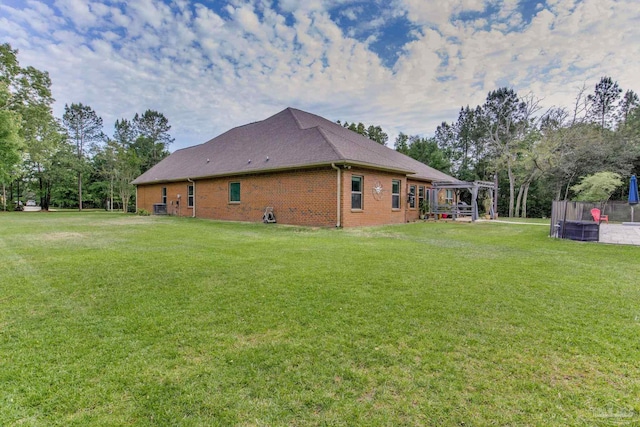 view of property exterior featuring a lawn, a pergola, and brick siding