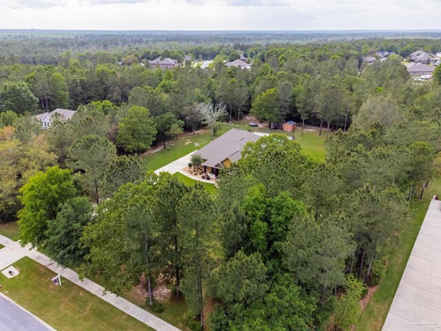 bird's eye view featuring a wooded view