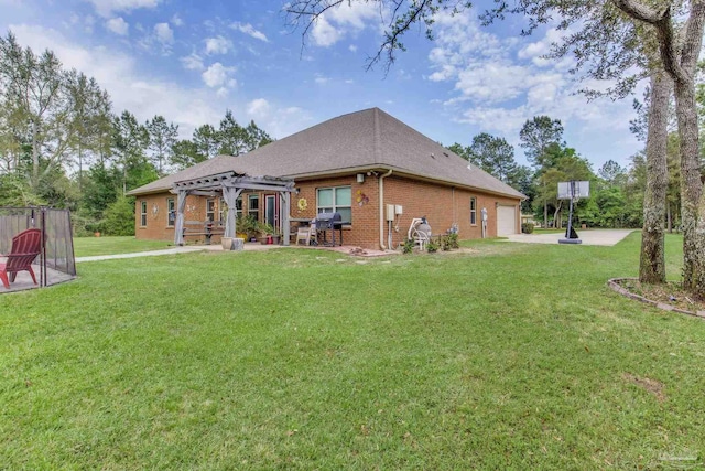 rear view of property featuring brick siding, an attached garage, a pergola, and a lawn