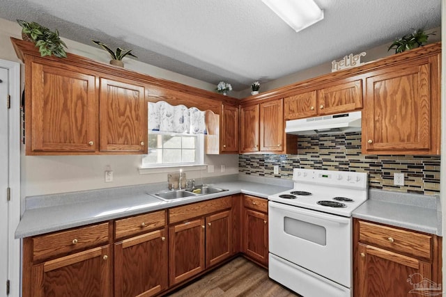 kitchen with white electric range, sink, dark hardwood / wood-style floors, decorative backsplash, and a textured ceiling