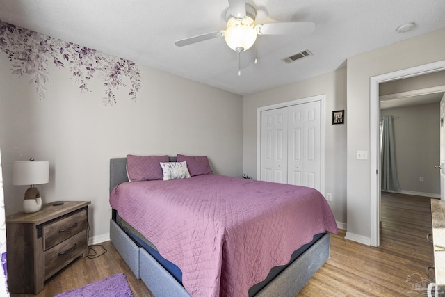 bedroom featuring ceiling fan, a closet, and hardwood / wood-style flooring